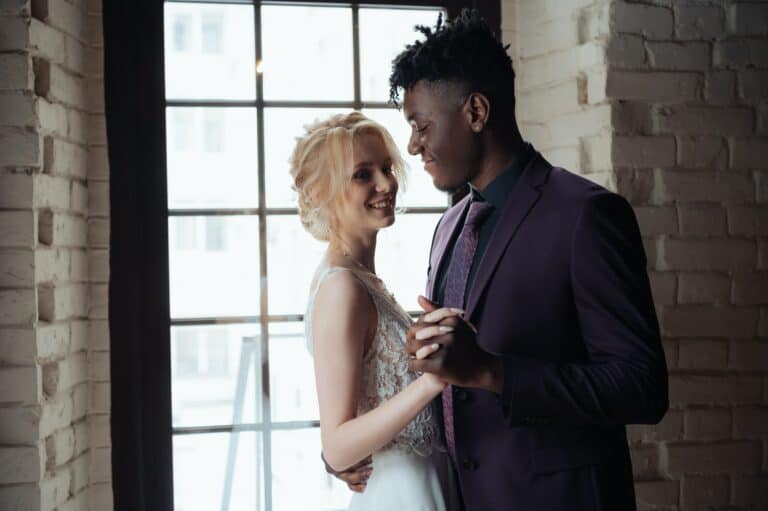 Interracial tender wedding couple. Young african american man and caucasian woman rehearse wedding